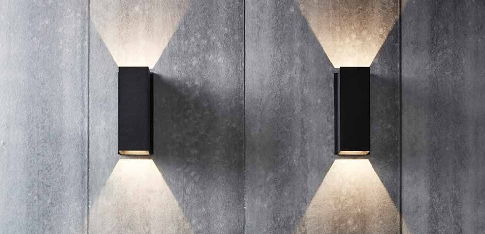 Two Black Wall Lights illuminating the wall.