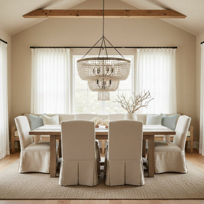 Beaded chandelier with wooden top and metal chain on a white background.