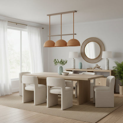 Modern dining room with wooden table, chairs, and pendant lights.