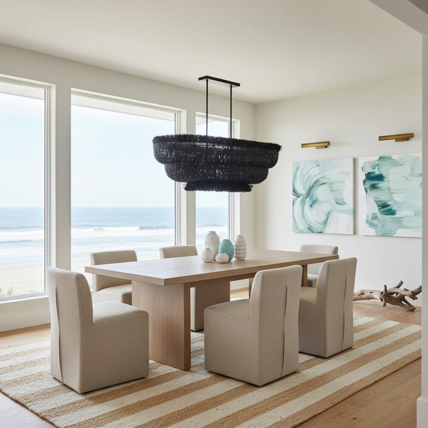 Modern dining room with a large window view, black chandelier, and abstract artwork.