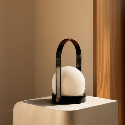 Carrie Outdoor LED Rechargeable Table Lamp in living room.