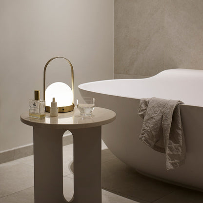 Carrie Outdoor LED Rechargeable Table Lamp in bathroom.