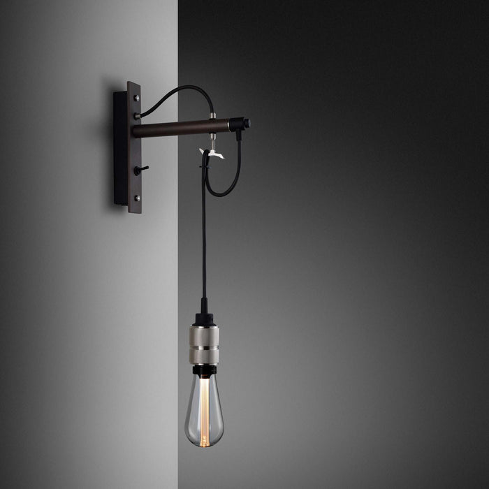 Hooked Nude Wall Light in Graphite/Steel.