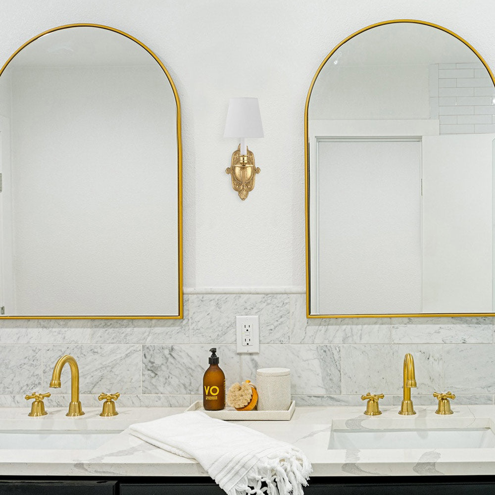 Cast Brass Ornate Wall Light in bathroom.