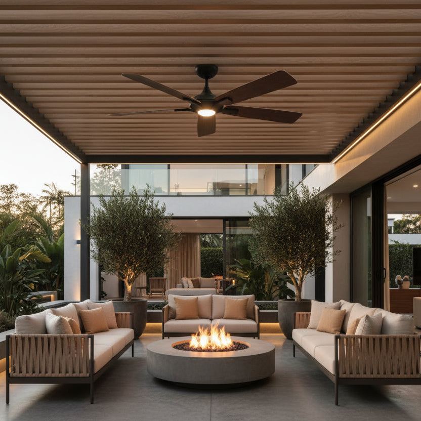 Ceiling fan with light on being used to fan back patio space around a campfire.
