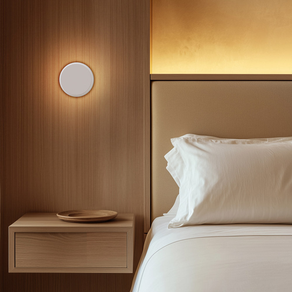 Totem Puck LED Wall Light in bedroom.