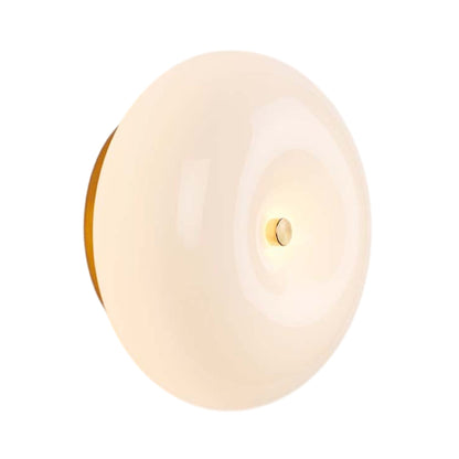 Pillow Round LED Wall Light in Unlacquered Brass.