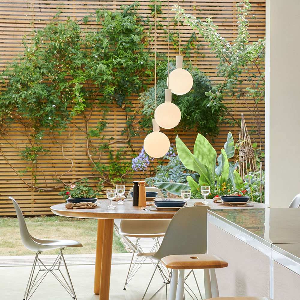 Alumina Sphere V LED Triple Pendant Light in living room.