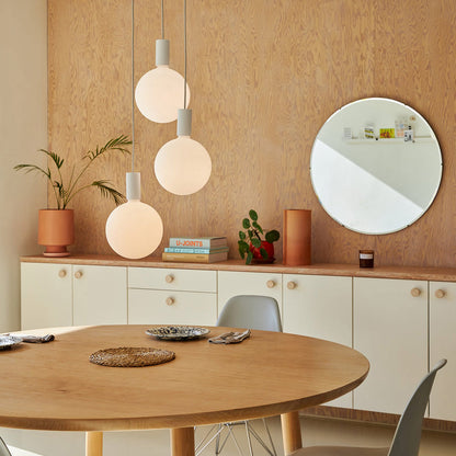 Alumina Sphere V LED Triple Pendant Light in living room.