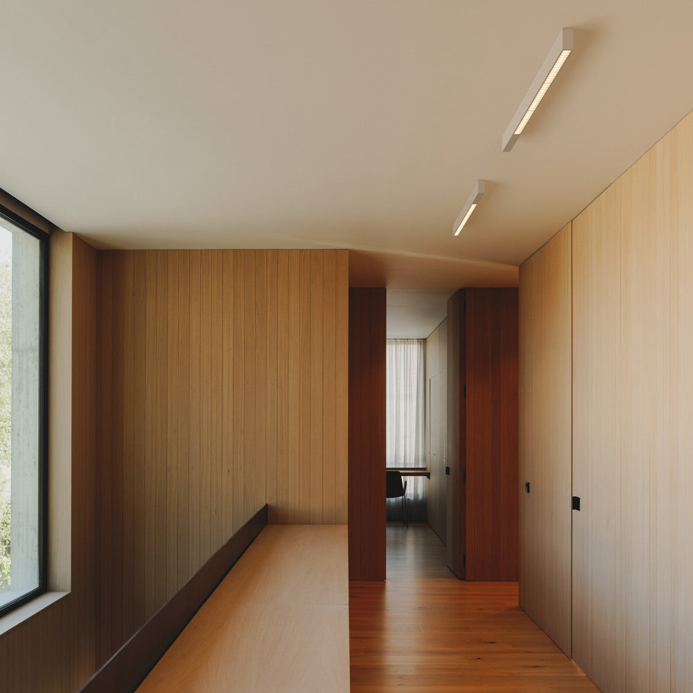 Offset LED Linear High Comfort Flush Mount Ceiling Light in hallway.