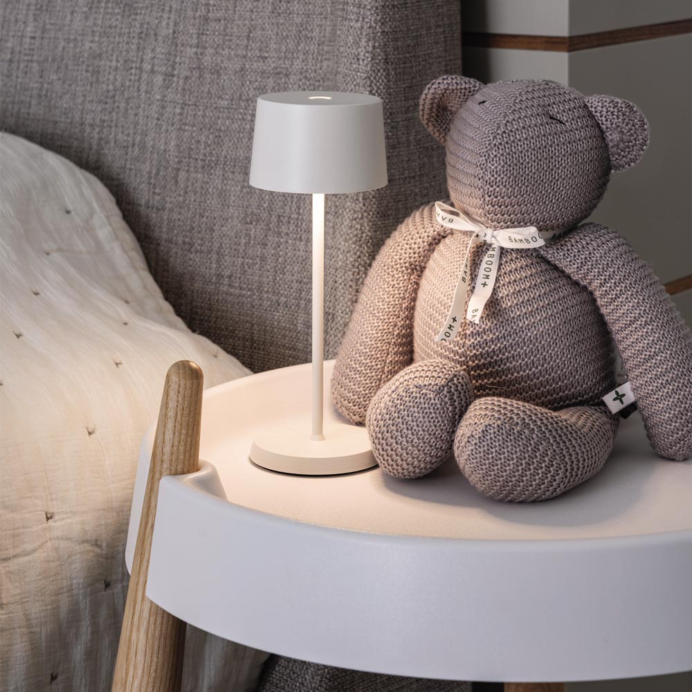 Olivia Pro Micro Outdoor Rechargeable LED Table Lamp in bedroom.