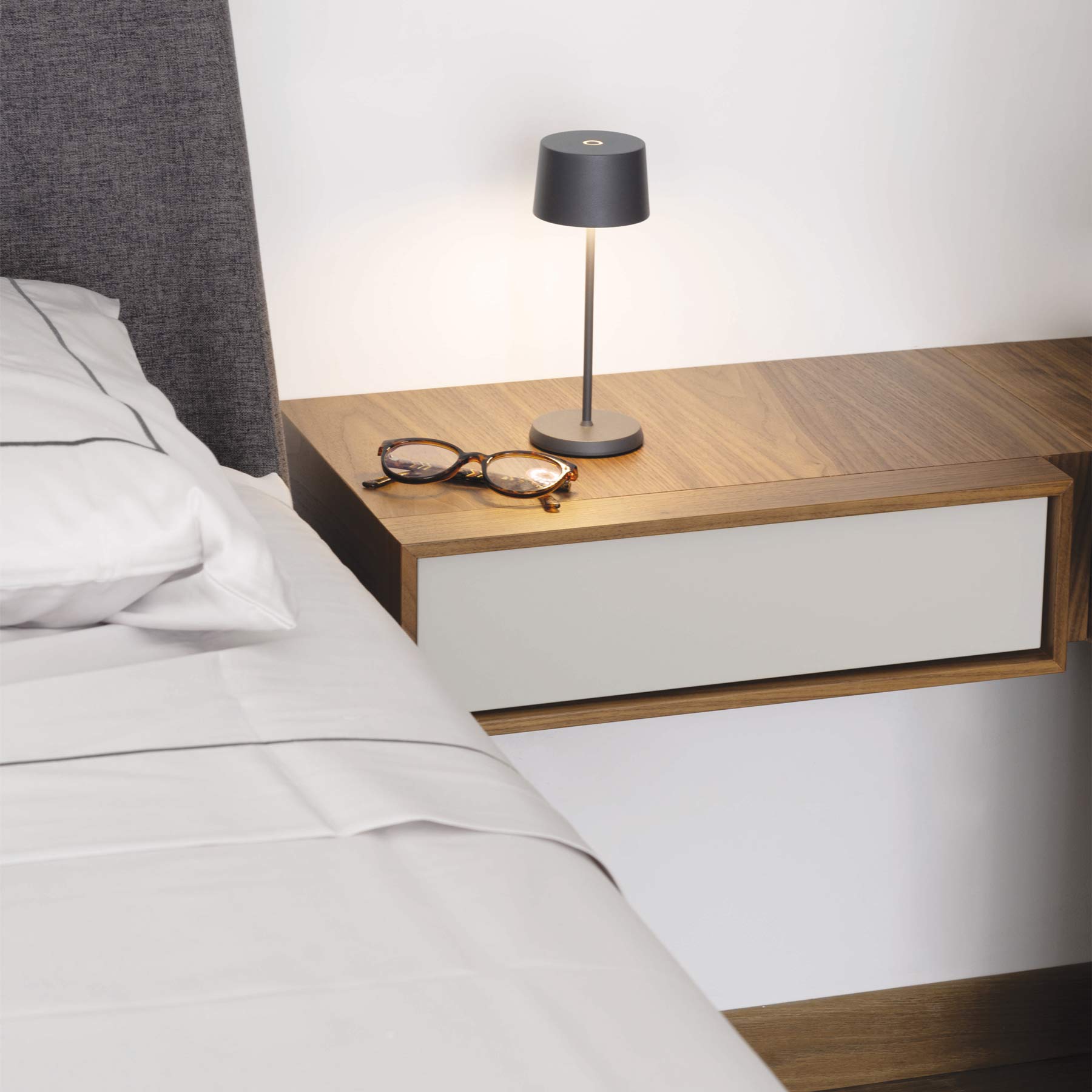 Olivia Pro Micro Outdoor Rechargeable LED Table Lamp in bedroom.