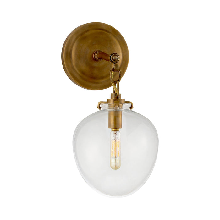 Katie Acorn Wall Light in Hand-Rubbed Antique Brass/Clear Glass.