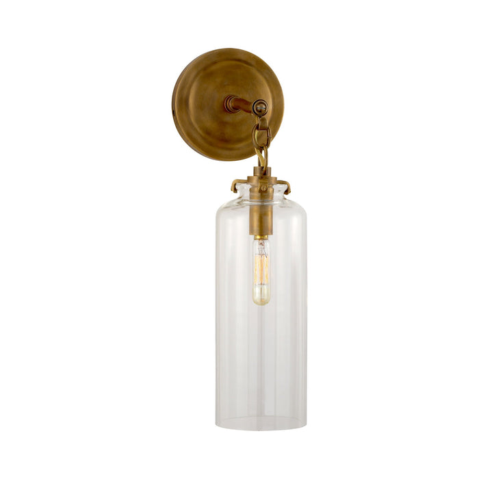 Katie Cylinder Wall Light in Hand-Rubbed Antique Brass/Clear Glass.
