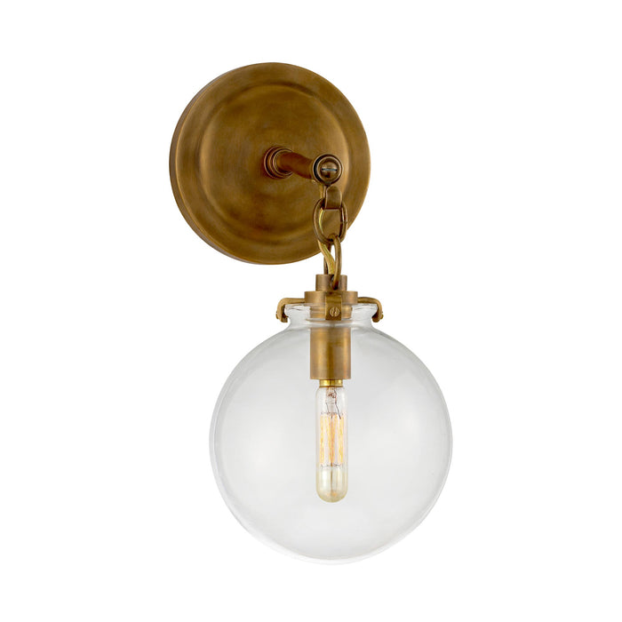 Katie Globe Wall Light in Hand-Rubbed Antique Brass/Clear Glass.