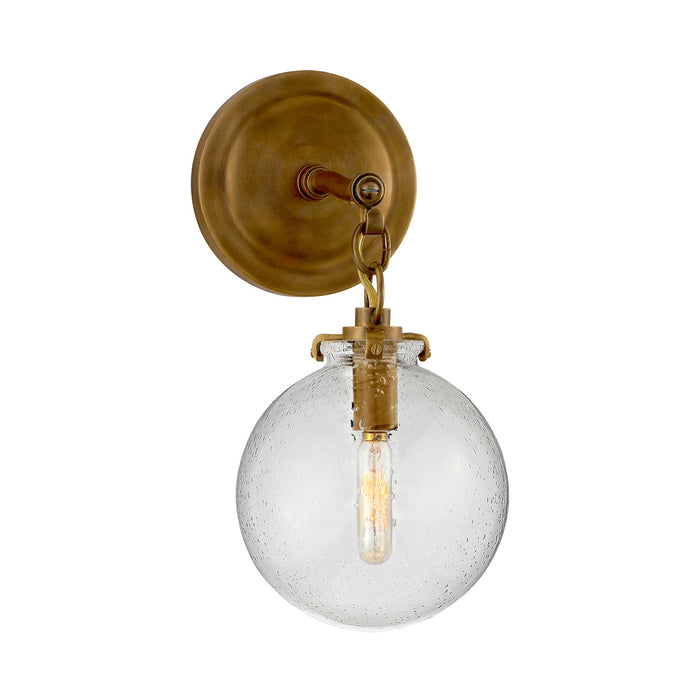 Katie Globe Wall Light in Hand-Rubbed Antique Brass/Seeded Glass.